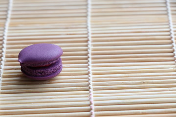 Obraz na płótnie Canvas Mini Macarons on bamboo mat colorful deserts