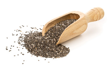 Whole dried black chai seeds in wooden scoop