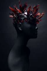 Black female mannequin in red and black metal head decoration