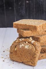 Fresh whole grain bread on white wood background