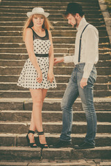 Loving couple retro style flirting on stairs