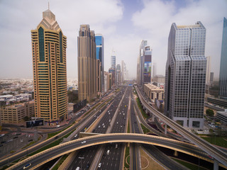 Fototapeta premium beautiful aerial view of futuristic city landscape with roads, cars, trains, skyscrapers. Dubai, UAE