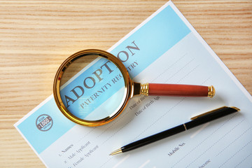 Magnifier and adoption form on table