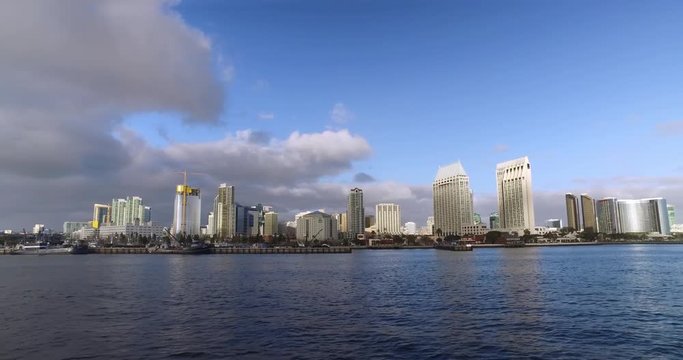 A wide, dramatic early evening establishing shot of the San Diego city skyline as seen from the bay.	 	