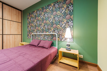 Interior bedroom with a large double bed with bedside tables, picture on the wall on a background...