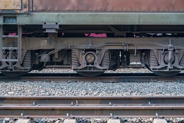 Close up detail of Suspension, shock absorber and wheels freight wagon - Diesel railcar