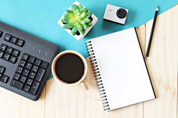 Business concept : Flat lay style of office workspace desk with blank notebook paper, computer...