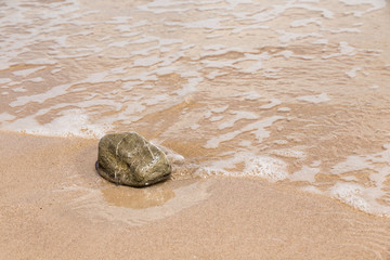 Small stone on sand beach