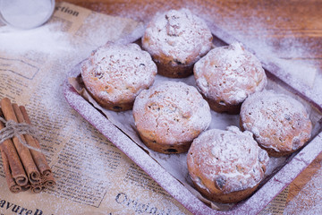 muffins with raisins on wooden background