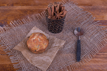 muffins with raisins on wooden background