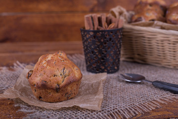 muffins with raisins on wooden background