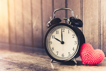 Love clock vintage tone timed 10 o'clock, Time of sweet loving past memories story on the old wood background.