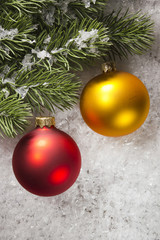 Balls and fir branch on snow