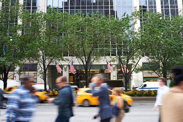 Fototapeta premium People walking in motion blur busy Manhattan street at rush hour