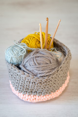 Crochet Yarn and Hooks in Knitted Woolen Basket