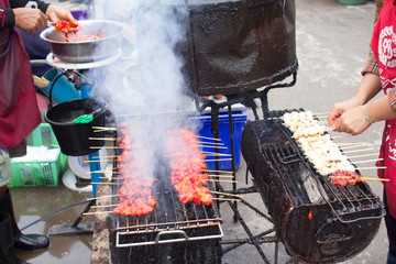 smoky food, smoke BBQ pork grill business sale at food stall rural market in Thailand.