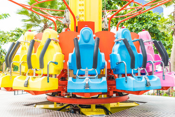 Colorful roller coaster seats at amusement park