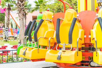 Colorful roller coaster seats at amusement park