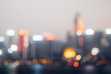 Blurred abstract background of cityscape at sea harbour hong kong at night time,urban life,vintage filter