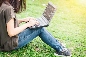 technology modern lifestyle, teen women using laptop computer with business data working in outdoor park.