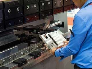 operator bending metal sheet by sheet bending machine, cnc control metal sheet bending machine,...
