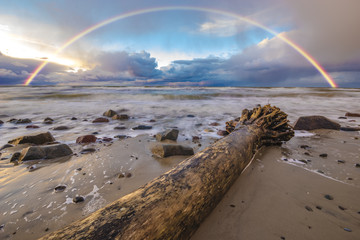 beautiful colored storm clouds over the sea beach, rainbow