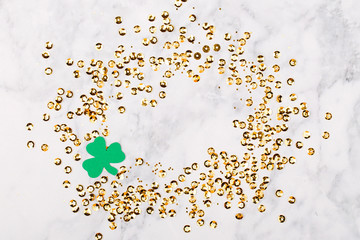 St.Patrick 's Day concept. Background with clover leafi and gold confetti frame. Mockup template. View from above