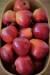 Red apples arranged in rustic bowl