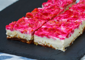 Vegan raw raspberry cheesecake on a dark background. Love for a healthy vegan food concept