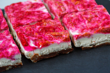 Vegan raw raspberry cheesecake on a dark background. Love for a healthy vegan food concept