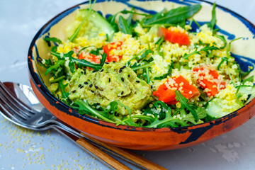 Green salad with couscous, avocado and fish.