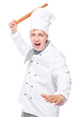 crazy chef attacking a wooden rolling pin on a white background