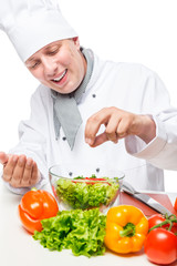 Portrait of a happy chef salad sprinkled with spices