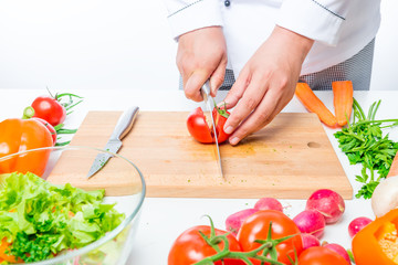 tomatoes on a cutting board in the hands of the chef