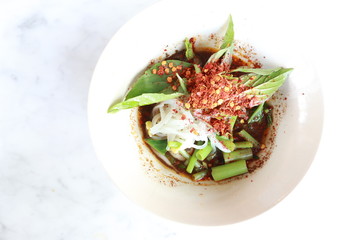 noodle with Basil leaf and red chilli in a white bowl on white background