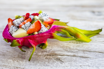 Fruit salad with dragon fruit and exotic fruits. Healthy diet and vegetarian food.