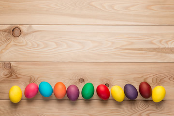chicken Easter eggs at the bottom of the frame, a wooden background space