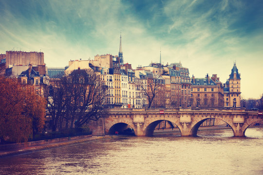 Pont Neuf in central Paris, France.  The Pont Neuf  is the oldest standing bridge across the river Seine in Paris. Toned image.