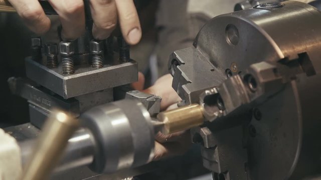 Close-up: the industrial setting of the machine and technical equipment for metal processing. Industrial theme: work plant or enterprise. Lathe or milling. Setting up equipment for metalworking.