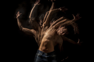 Strobo portrait of shirtless handsome man . Black background