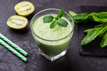Healthy green smoothie with spinach and kiwi in a glass