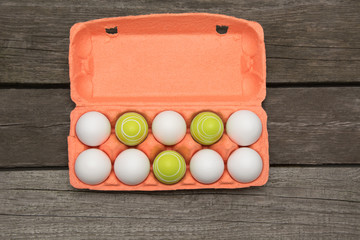 Carton of organic eggs on wooden background. Top view.