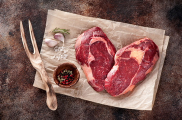 Raw fresh meat Ribeye Steak heart shape on brown paper