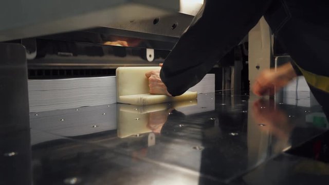 Printing press, paper cutting on the cutting machine, printing production. 4k footage.
