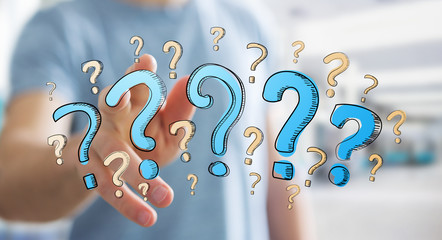 Businessman touching hand drawn question marks with his fingers