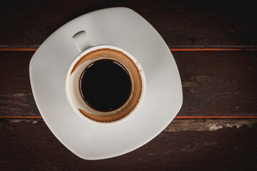 That cup of coffee stains on white placed on a wooden table