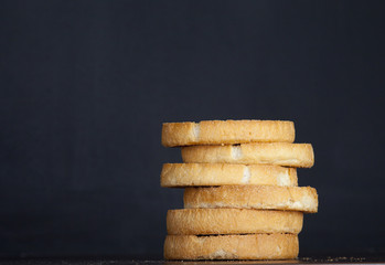 Pile of Dutch beschuit on black dark background