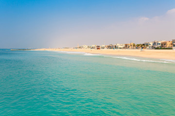 Naklejka premium Panoramic view on nice Jumeirah beach in Dubai, UAE. United Arab Emirates famous tourist destination. Clear blue water Persian gulf, Indian Ocean