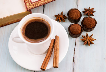 A cup of coffee with chocolate truffles