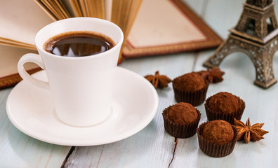 Beautiful still life with a cup of coffee and truffles